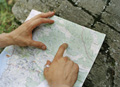 hands pointing out features on a map